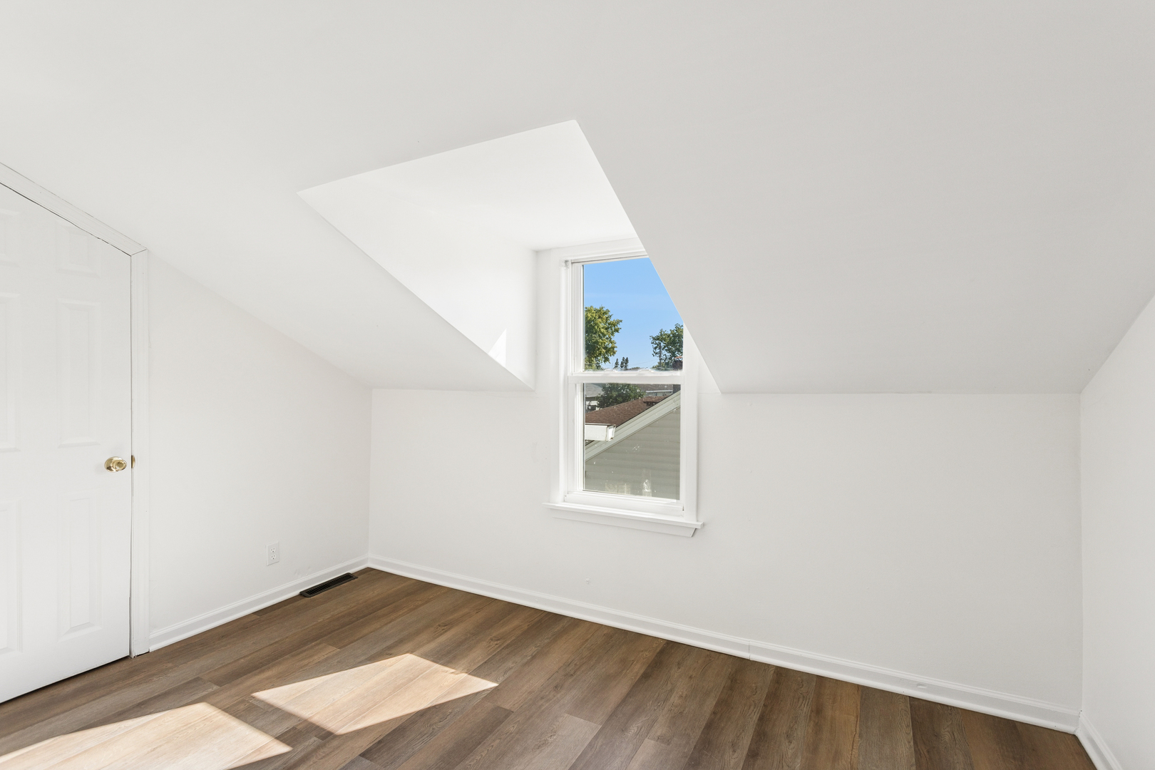 540 East 4th Street Lockport, IL 60441 - Photo 13 of 24 an empty room with wooden floor and windows
