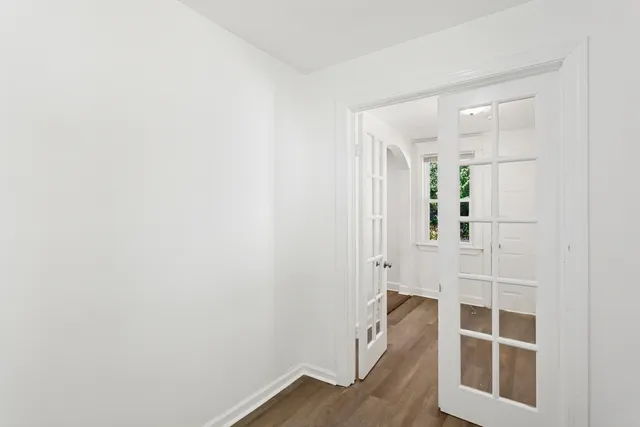 a view of wooden floor and windows in a room
