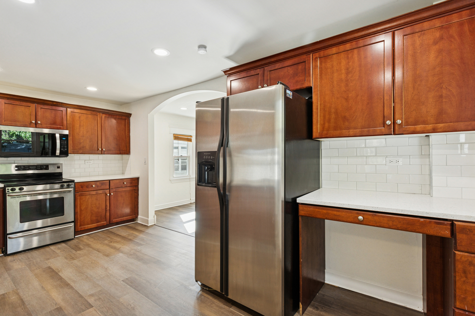 540 East 4th Street Lockport, IL 60441 - Photo 3 of 24 a kitchen with stainless steel appliances granite countertop a refrigerator a sink and a stove