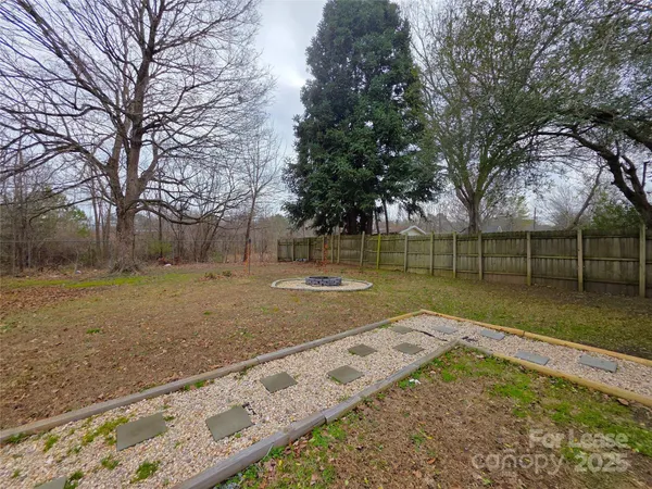 a view of a yard with large trees