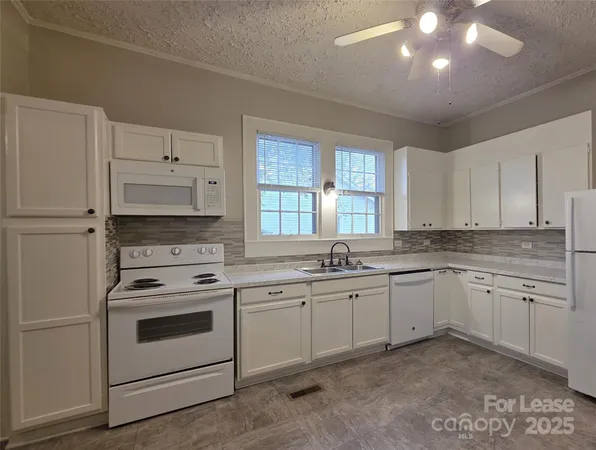 a kitchen with a sink stove and cabinets