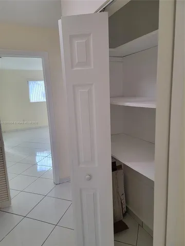 a room with walk in closet and window