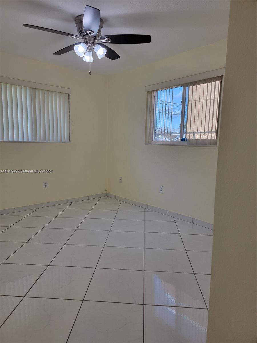 1037 West 23rd Street Hialeah, FL 33010 - Photo 13 of 41 a view of an empty room with a window