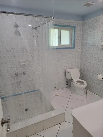 a bathroom with a bathtub and shower