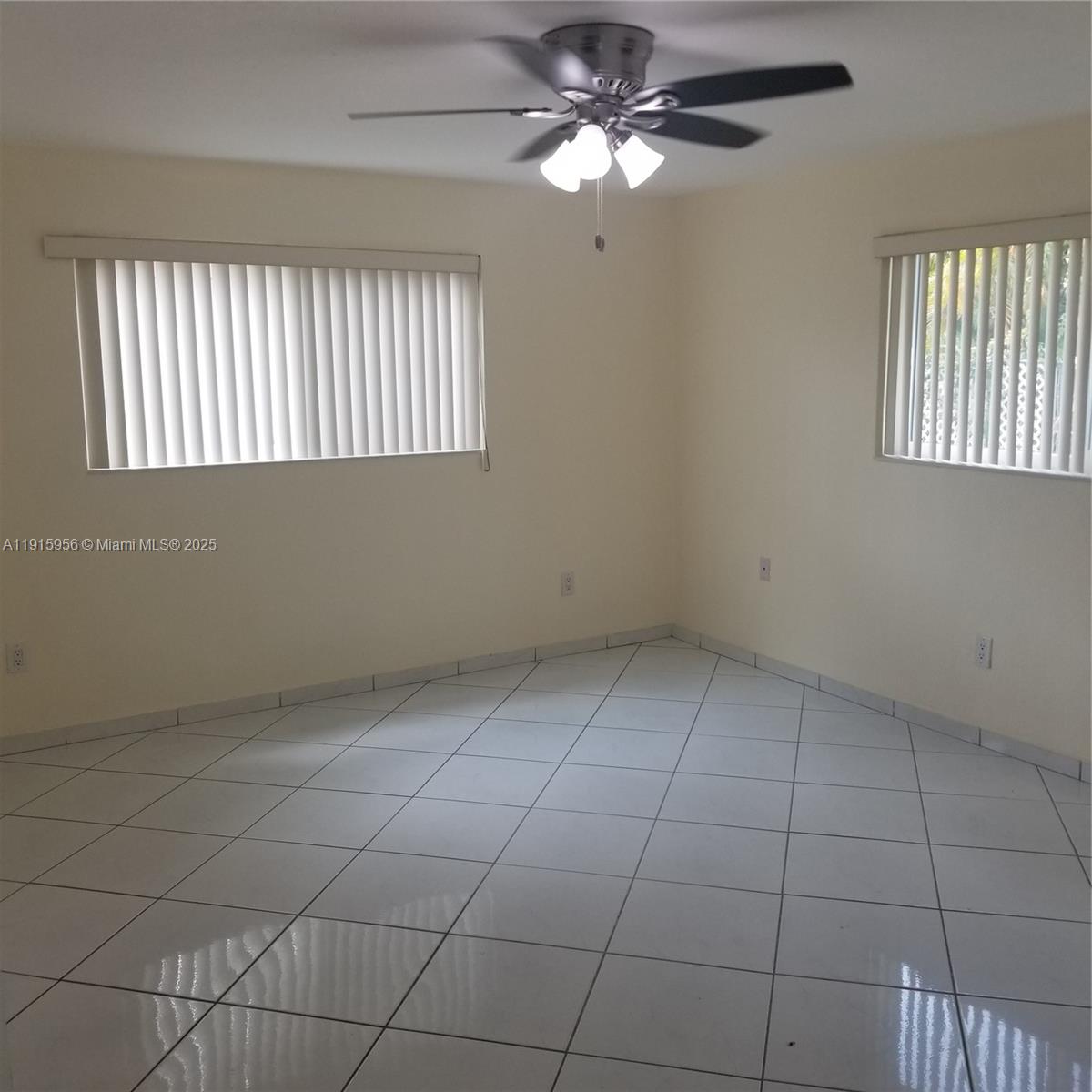 1037 West 23rd Street Hialeah, FL 33010 - Photo 20 of 41 an empty room with windows and fan