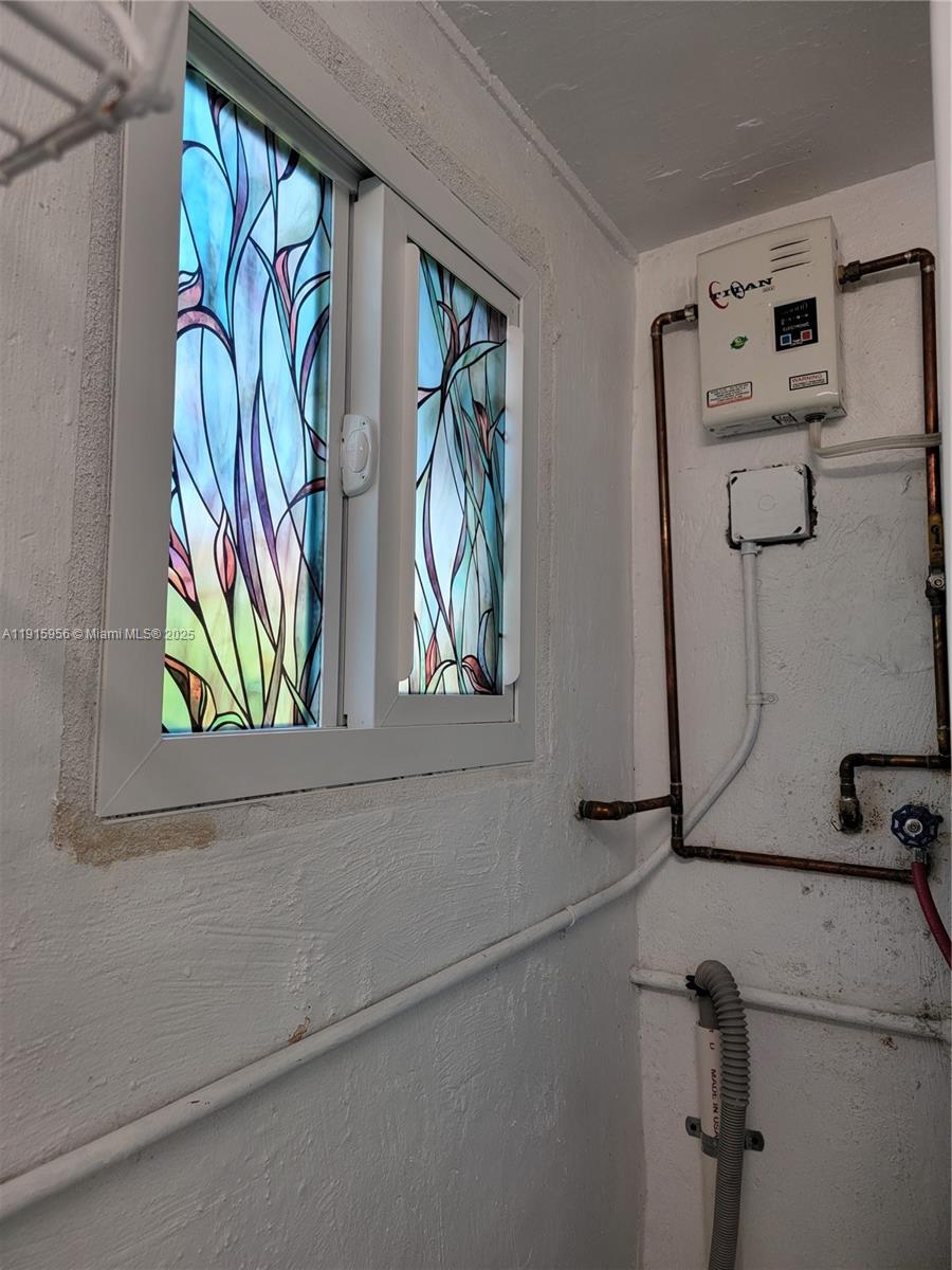 1037 West 23rd Street Hialeah, FL 33010 - Photo 23 of 41 a bathroom with a bathtub and a window