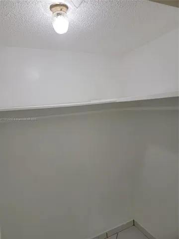 a bathroom with a granite countertop toilet sink and mirror