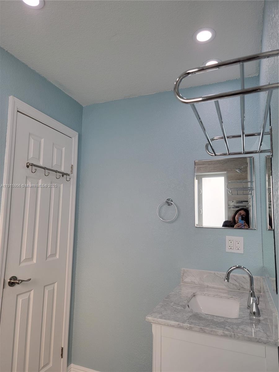 1037 West 23rd Street Hialeah, FL 33010 - Photo 30 of 41 a bathroom with a sink and a mirror