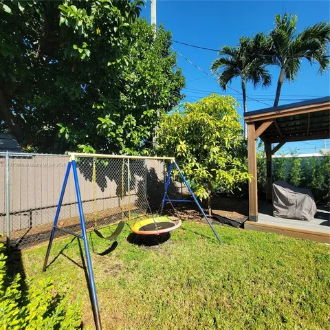 a view of a patio with table and chairs potted plants with wooden floor