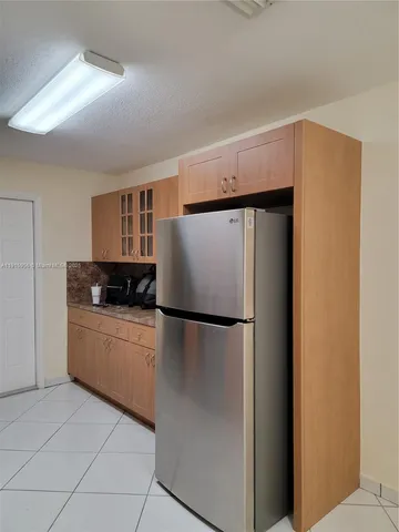 a kitchen with a refrigerator and a stove