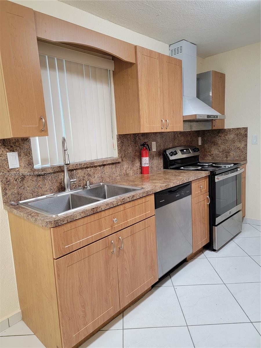 1037 West 23rd Street Hialeah, FL 33010 - Photo 7 of 41 a kitchen with stainless steel appliances granite countertop a sink stove and cabinets