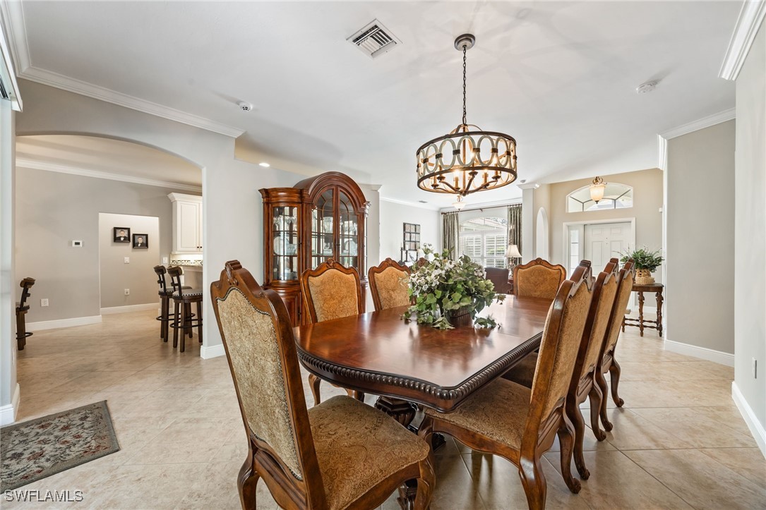 12977 Turtle Cove Trail North Fort Myers, FL 33903 - Photo 14 of 45 a view of a dining room and chandelier