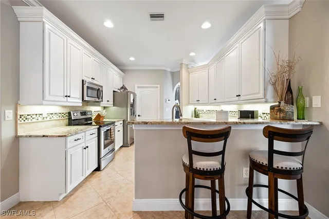 a kitchen with stainless steel appliances granite countertop a stove a sink a stove a microwave and a refrigerator