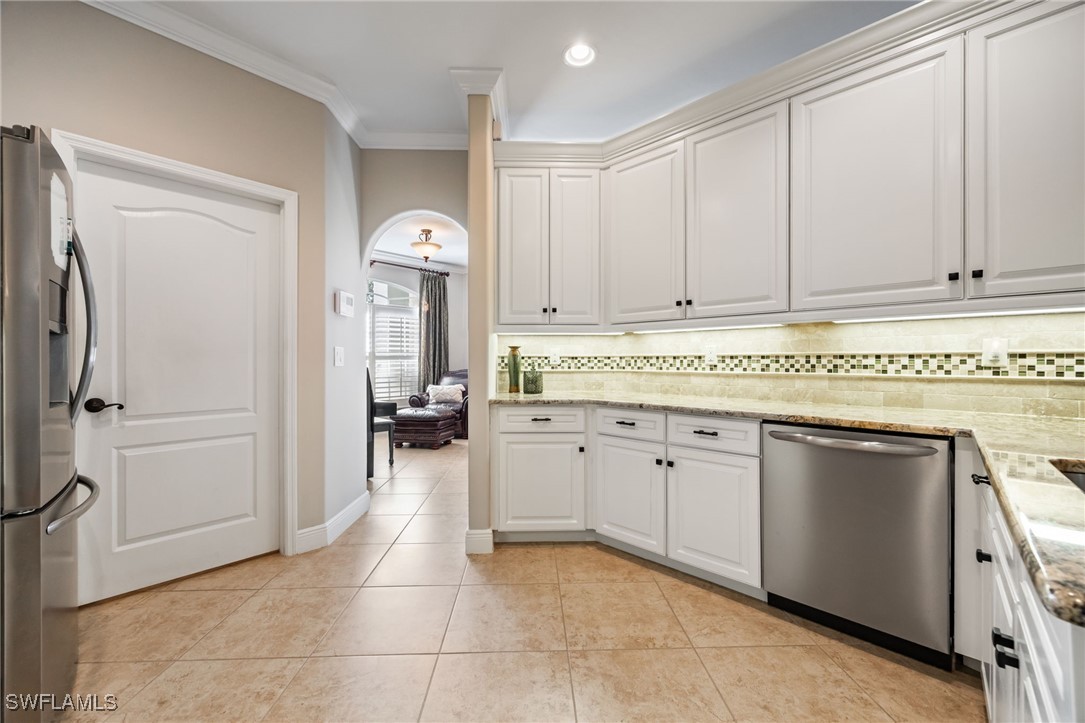 12977 Turtle Cove Trail North Fort Myers, FL 33903 - Photo 16 of 45 a kitchen with a refrigerator and cabinets
