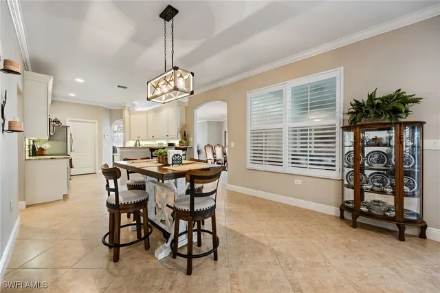 a view of a dining room with furniture and a chandelier