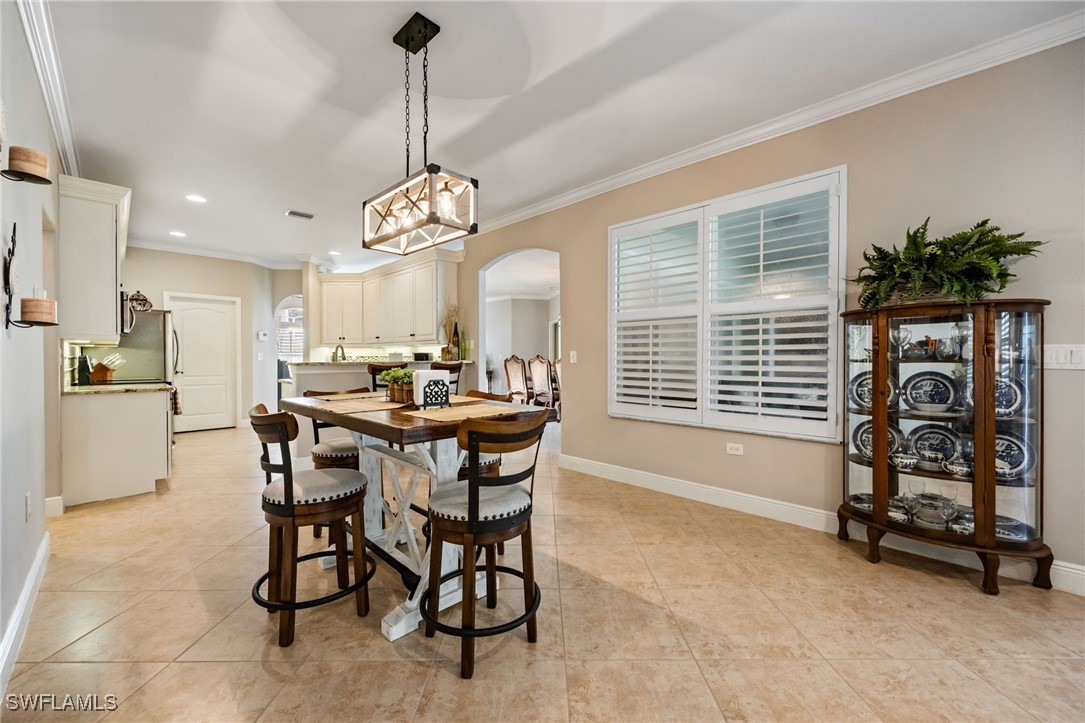 12977 Turtle Cove Trail North Fort Myers, FL 33903 - Photo 24 of 45 a view of a dining room with furniture and a chandelier
