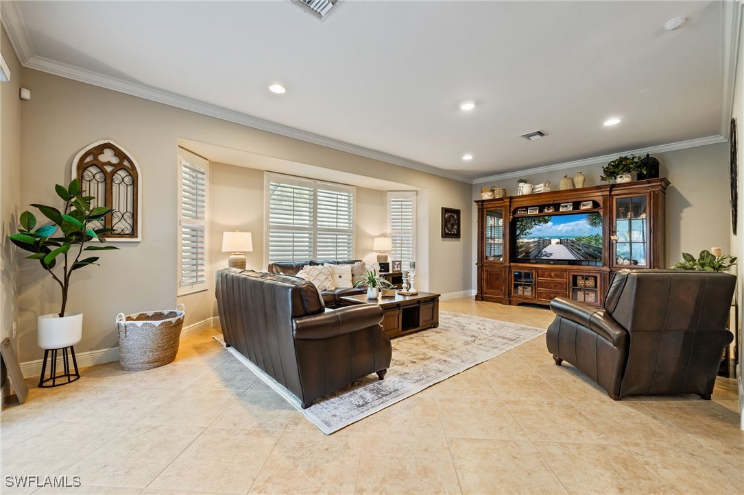 12977 Turtle Cove Trail North Fort Myers, FL 33903 - Photo 25 of 45 a living room with furniture and a flat screen tv