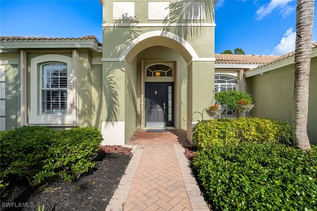 a view of a house with potted plants