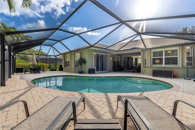 a view of a house with backyard and sitting area