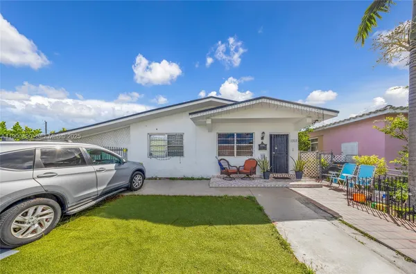 a front view of a house with a garden and patio