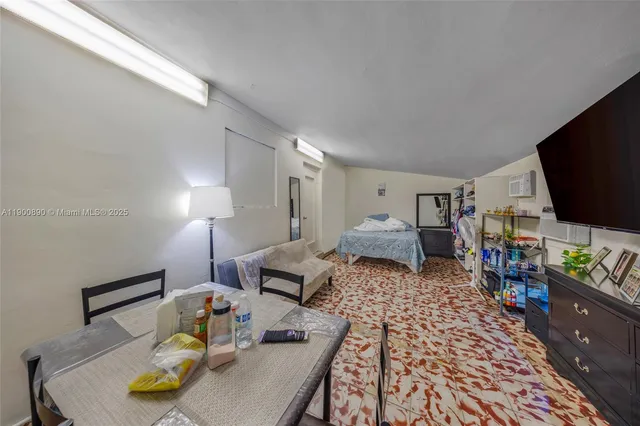 a bedroom with furniture and a flat screen tv