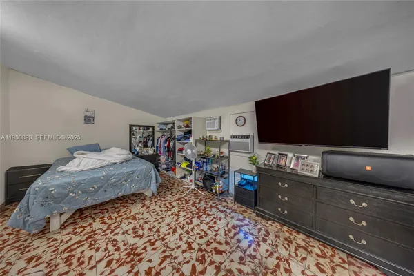 a bedroom with a bed and a flat screen tv