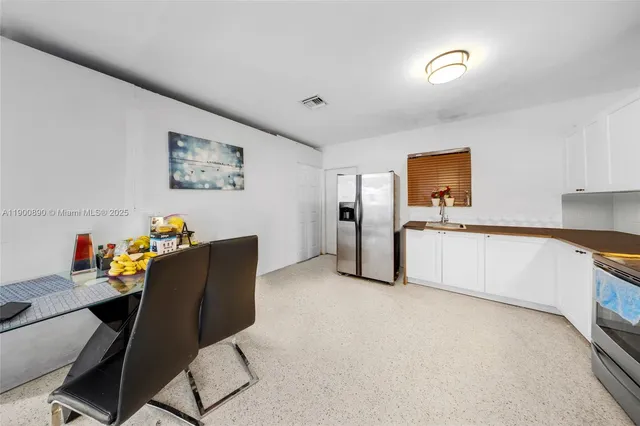 a workspace with furniture and a kitchen space