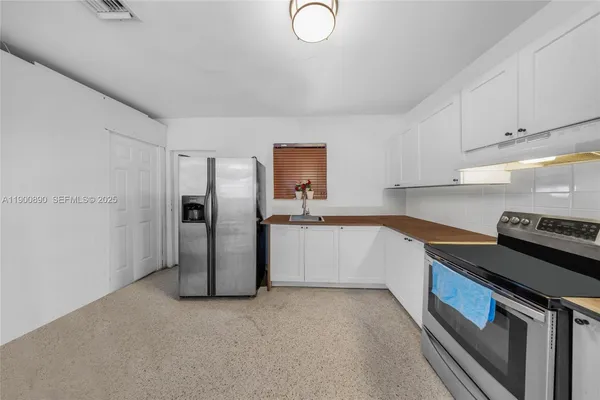 a kitchen with a refrigerator sink and stove