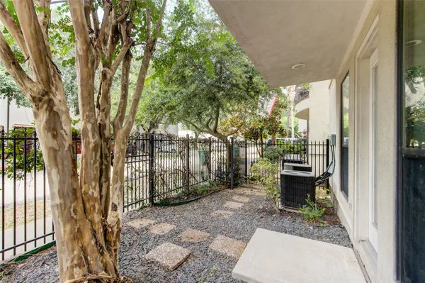 a backyard of a house with barbeque oven and outdoor seating