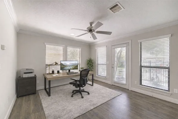 a view of a workspace with furniture and a window