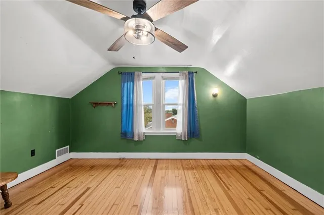 a view of a room with a large window and entryway