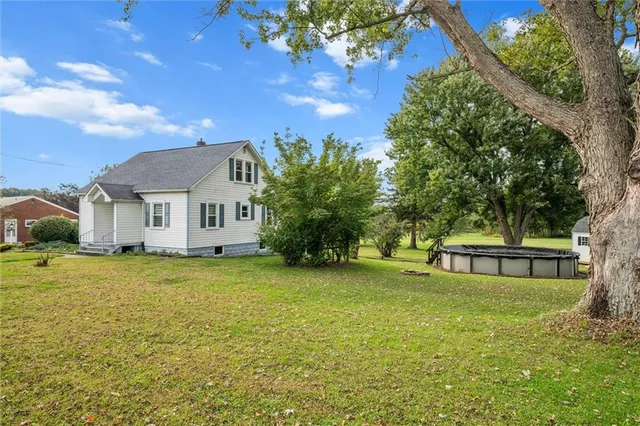 a yellow house with pool in front of it