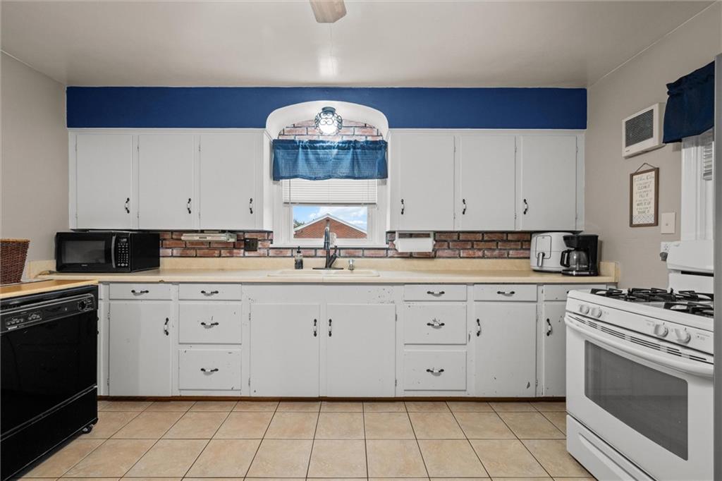 429 Marwood Road Cabot, PA 16023 - Photo 5 of 35 a kitchen with granite countertop white cabinets and white appliances