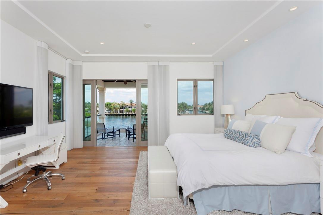 23 Saranac Road Sea Ranch Lakes, FL 33308 - Photo 18 of 29 a bedroom with a bed a large window table and chairs