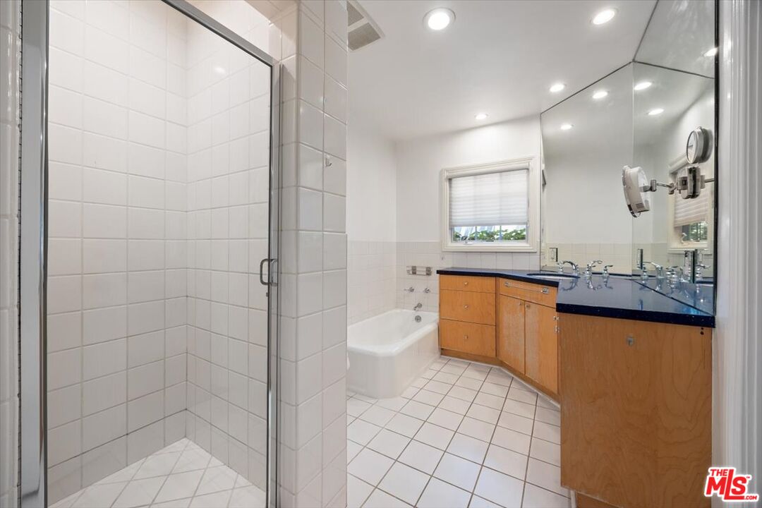 14041 Roblar Road Sherman Oaks, CA 91423 - Photo 24 of 47 a bathroom with a granite countertop sink a toilet and shower