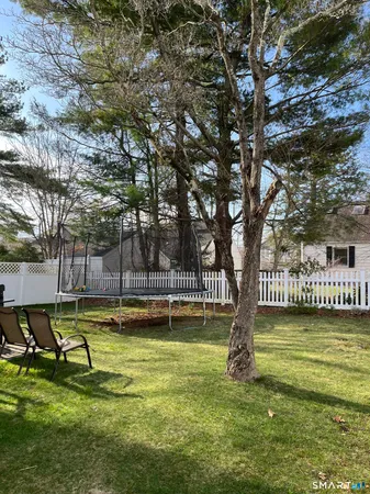 a view of a swimming pool with a bench and trees