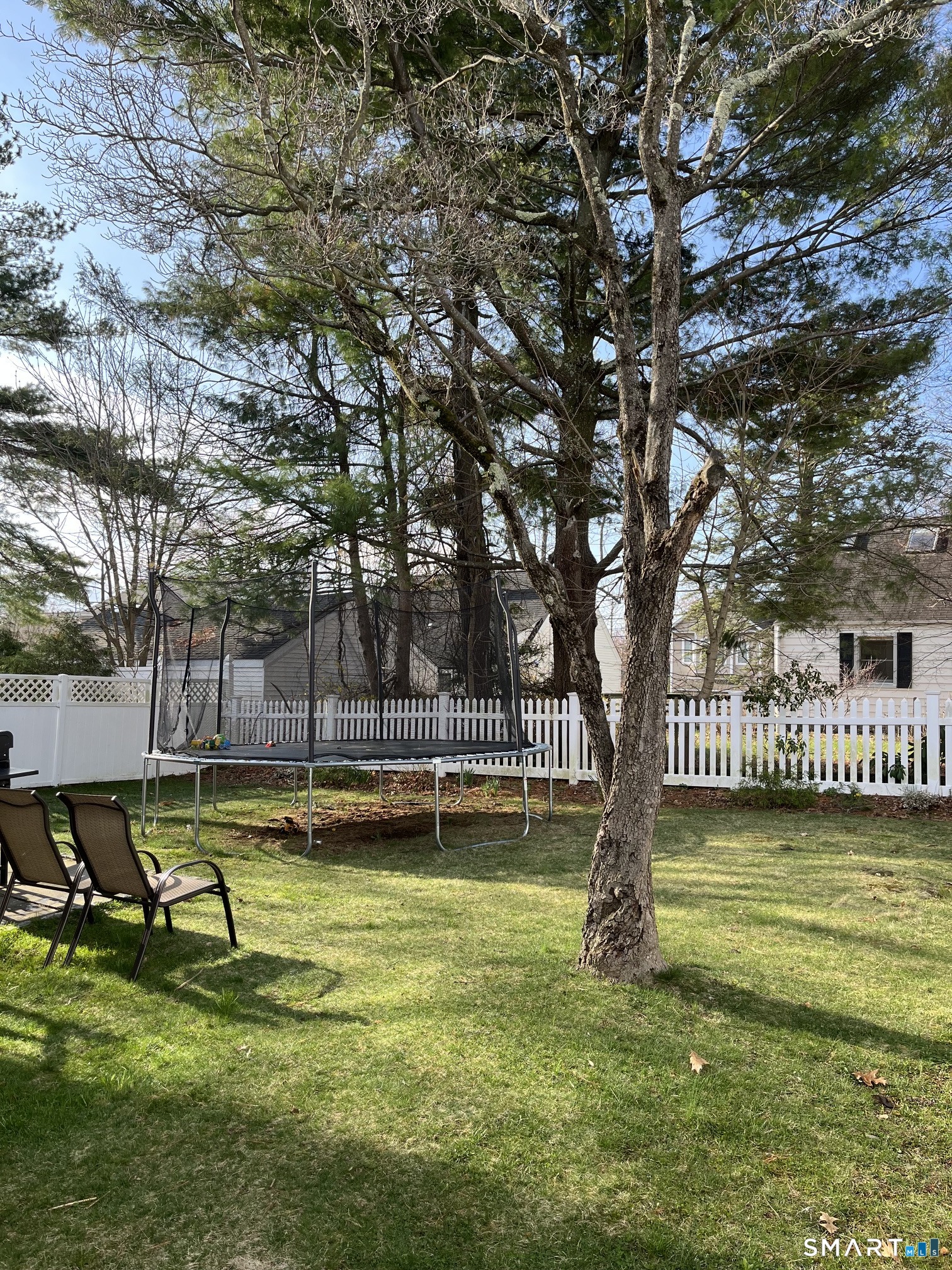 175 Alvin Street, Unit 175 Fairfield, CT 06825 - Photo 9 of 11 a view of a swimming pool with a bench and trees