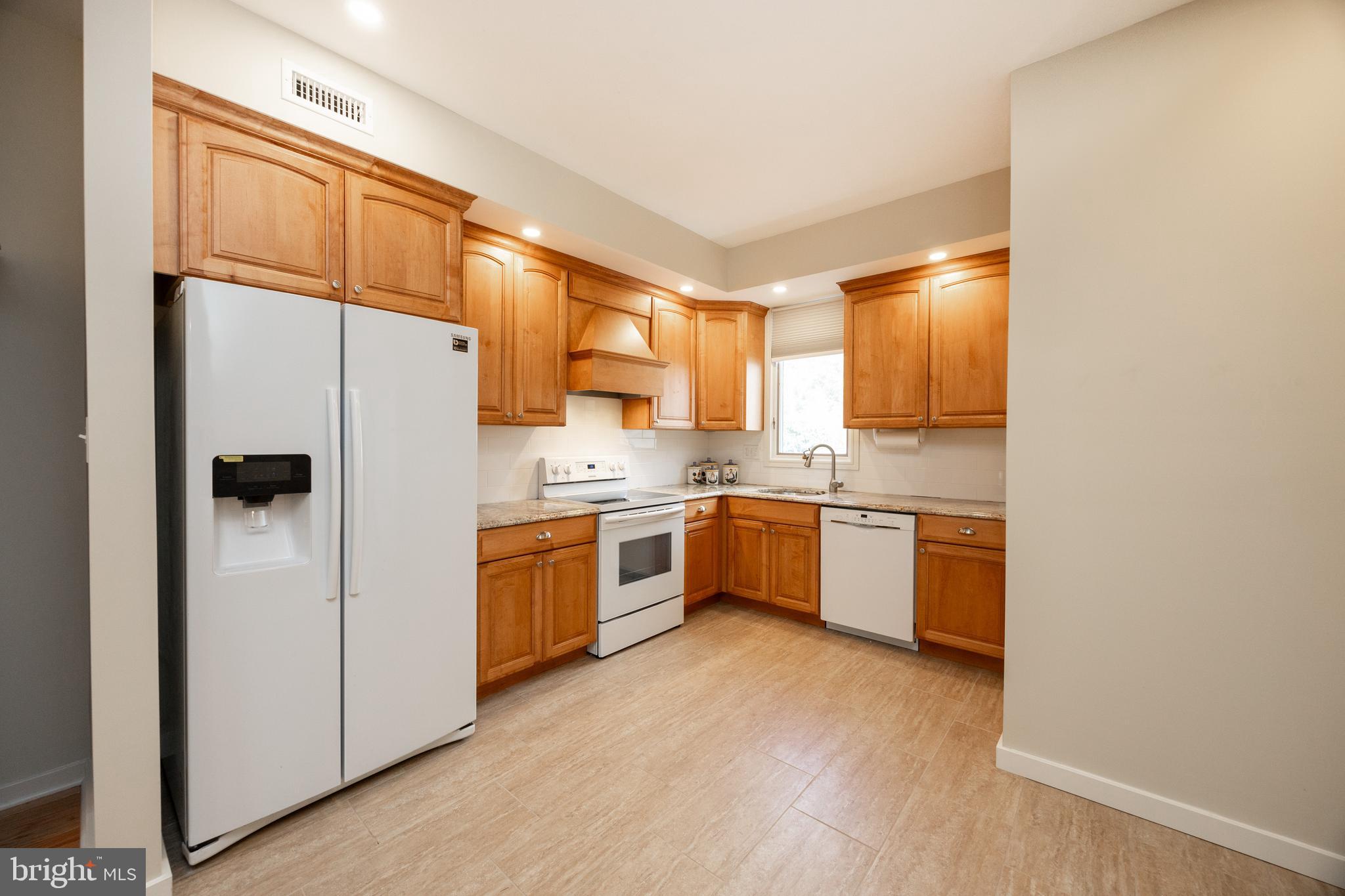 9 Avignon, Unit 9 Devon, PA 19333 - Photo 12 of 37 a kitchen with a refrigerator sink and cabinets