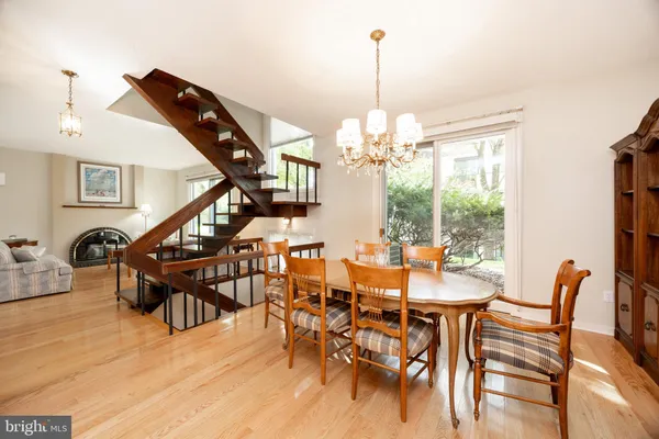 a view of a dining room with furniture wooden floor and chandelier