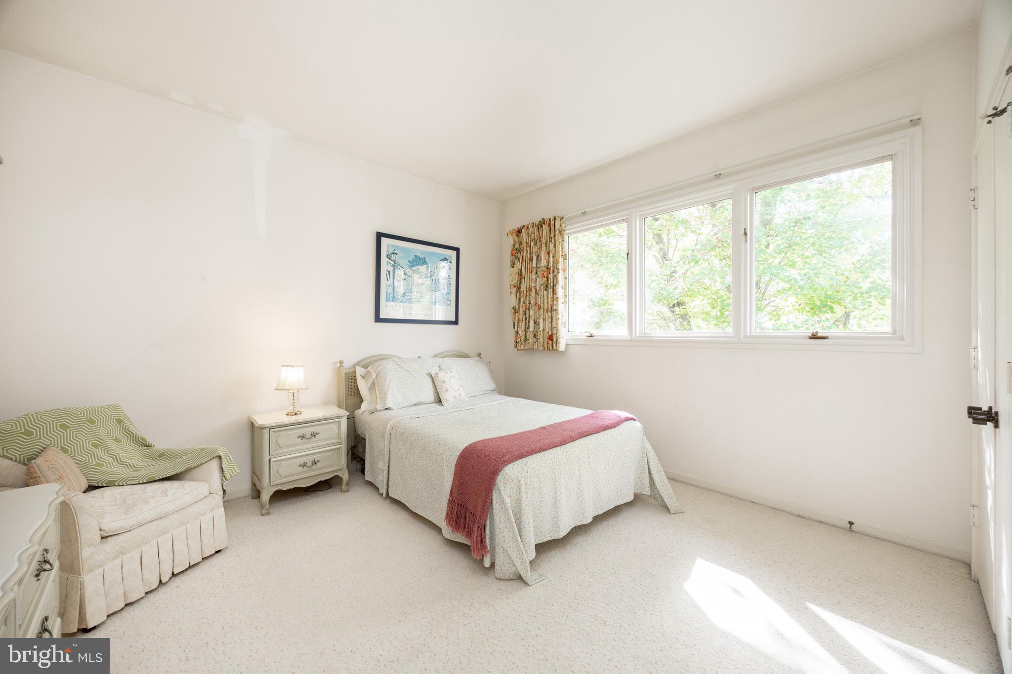 9 Avignon, Unit 9 Devon, PA 19333 - Photo 22 of 37 a spacious bedroom with a bed and a couch