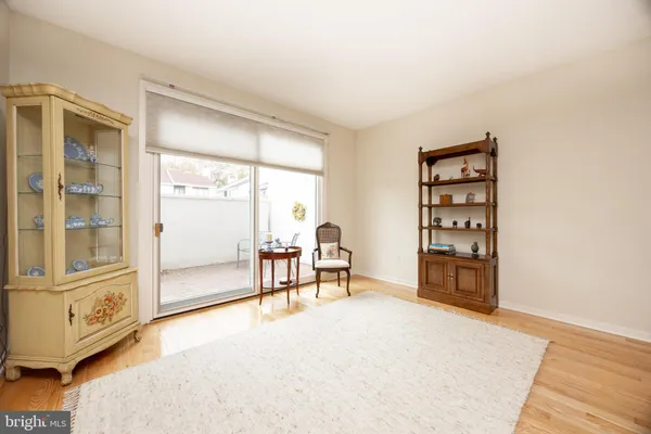 a living room with furniture a flat screen tv and a window