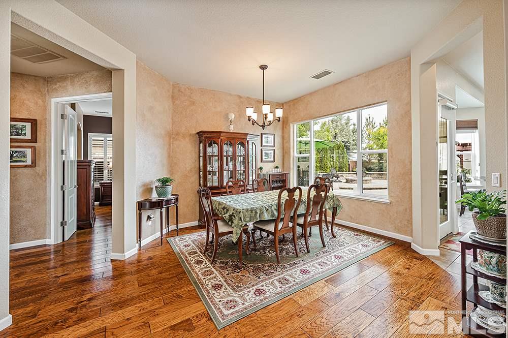 2905 Bull Rider Drive Reno, NV 89521 - Photo 11 of 33 a dining room with wooden floor a chandelier a wooden table and chairs