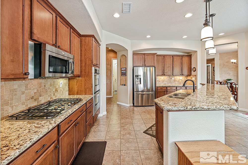 2905 Bull Rider Drive Reno, NV 89521 - Photo 16 of 33 a kitchen with stainless steel appliances granite countertop a stove and a sink