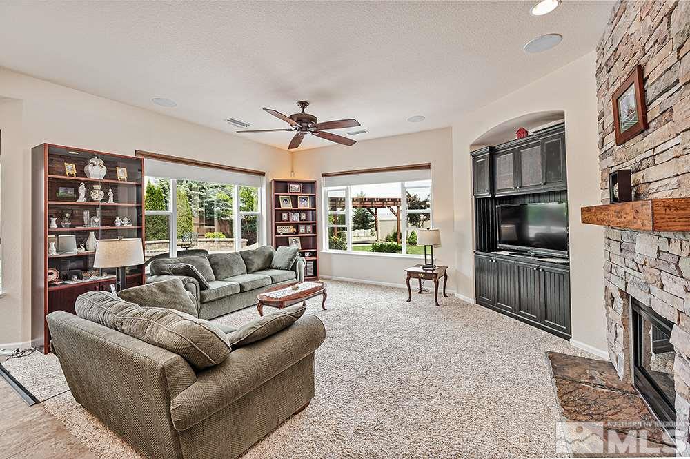 2905 Bull Rider Drive Reno, NV 89521 - Photo 18 of 33 a living room with furniture a fireplace and a flat screen tv