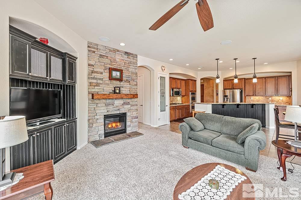 2905 Bull Rider Drive Reno, NV 89521 - Photo 20 of 33 a living room with fireplace furniture and a flat screen tv