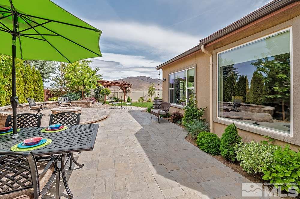 2905 Bull Rider Drive Reno, NV 89521 - Photo 27 of 33 a patio with a table and chairs under an umbrella