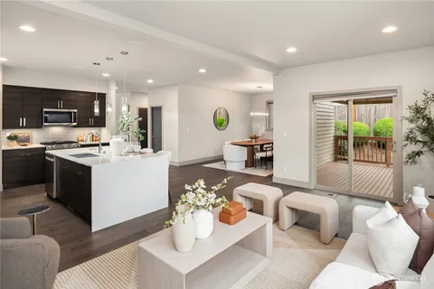 a living room with furniture kitchen and a table