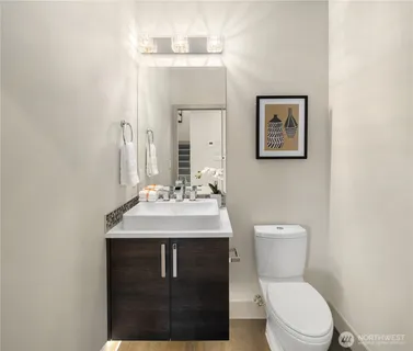 a bathroom with a toilet sink and mirror