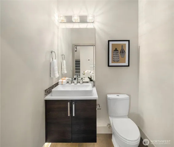 a bathroom with a toilet sink and mirror