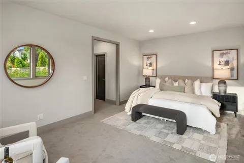 a bedroom with a bed and a painting on the wall